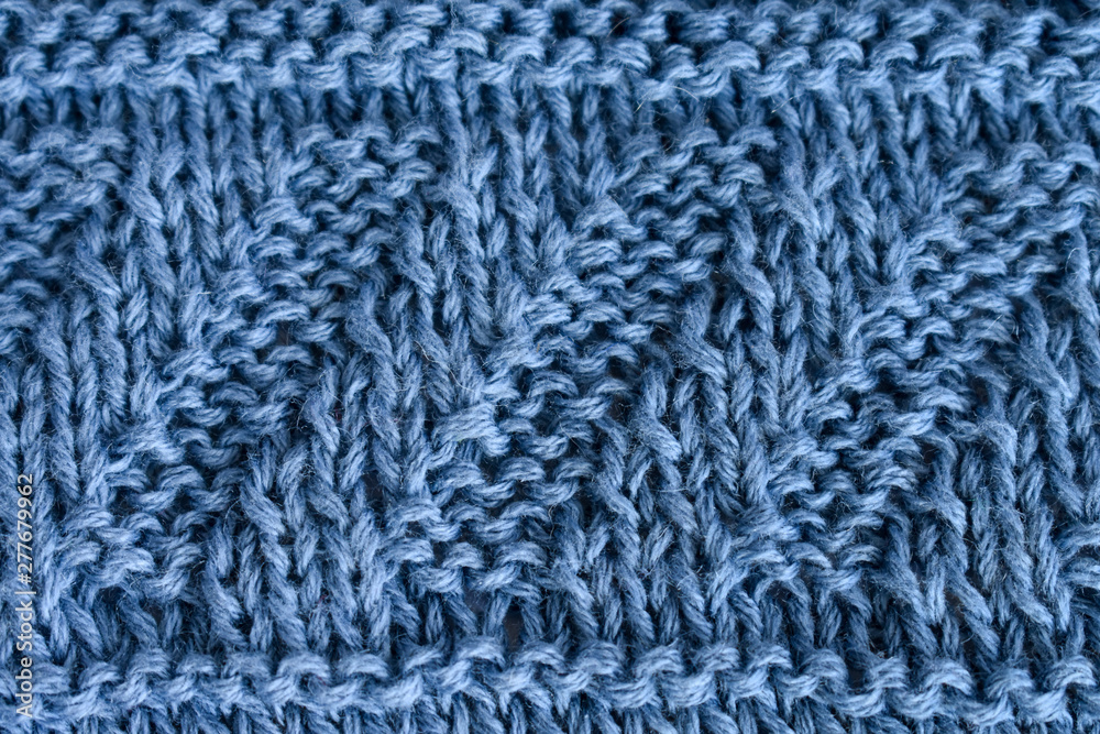 Knitting diagonal pattern of natural blue wool Knitting diagonal pattern of natural blue wool