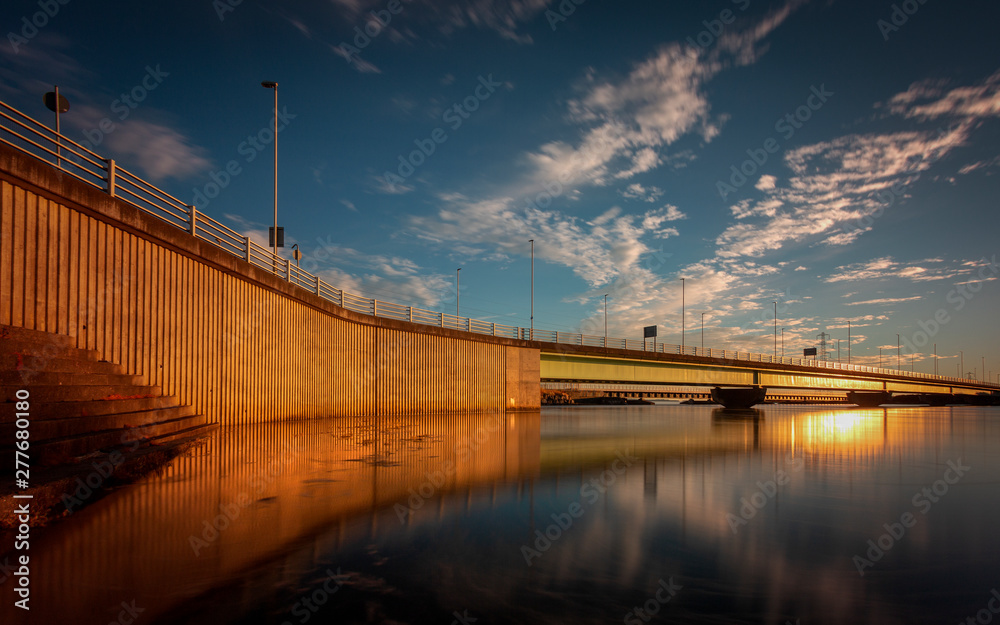 Obraz premium Loughor estuary road bridge Sunset and high tide at the bridge over the Loughor estuary linking Swansea to Llanelli in South Wales, UK