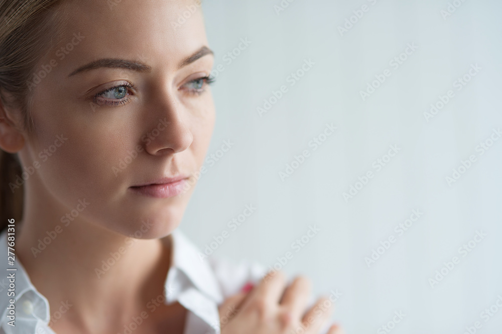 Emotion Concept. Woman standing isolated on white looking aside pensive close-up Emotion Concept. Woman standing isolated on white looking aside pensive close-up