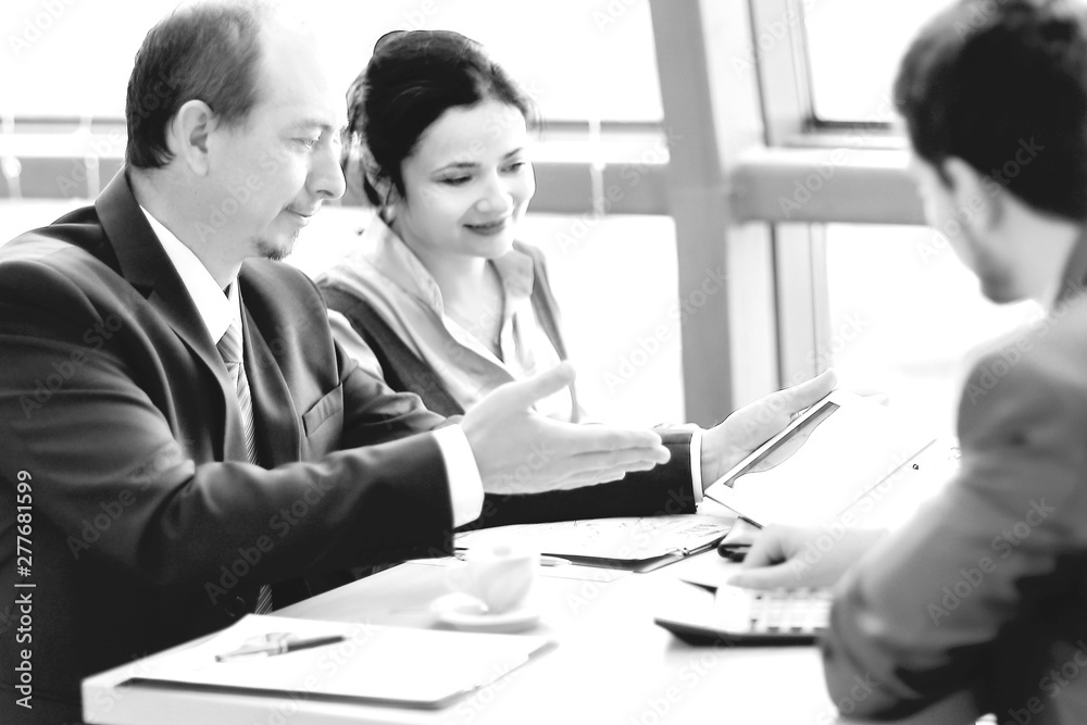businessman and assistants discuss the work schedule. businessman and assistants discuss the work schedule.