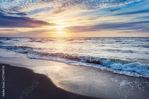 Fototapeta Naklejka Na Ścianę i Meble -  Sea at sunset. Sun reflection in waves.
