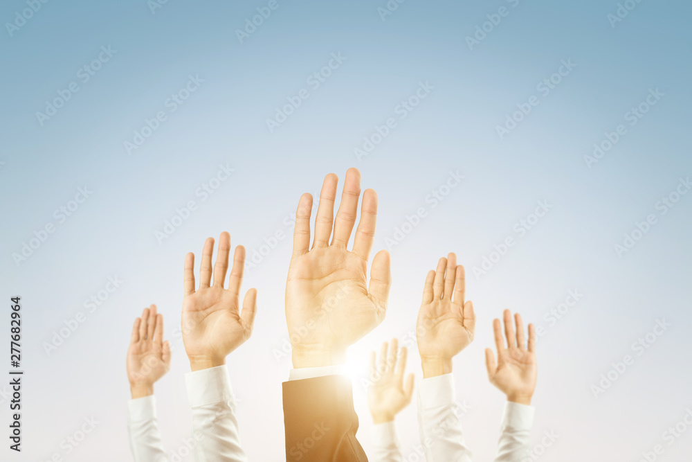 Businessmen raised their hands to win the celebration of the organization.The concept of business is geared towards success,sunlight effect.