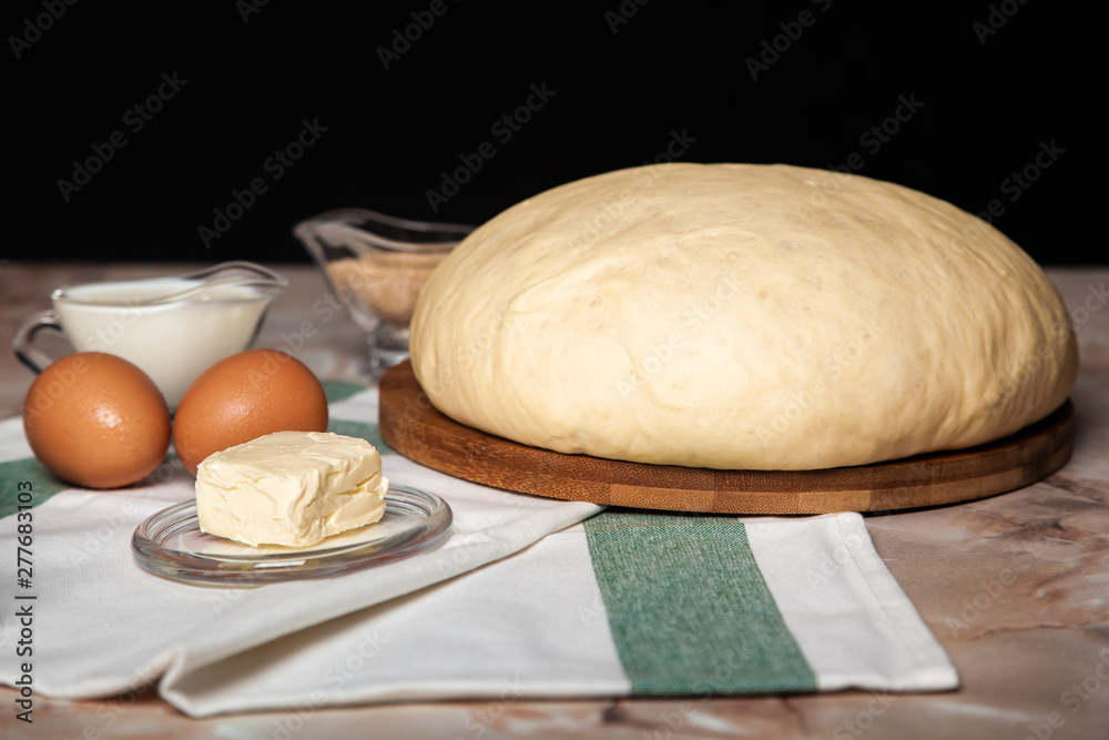 Bakery ingredients. On the table are flour, eggs and pastry dough Bakery ingredients. On the table are flour, eggs and pastry dough