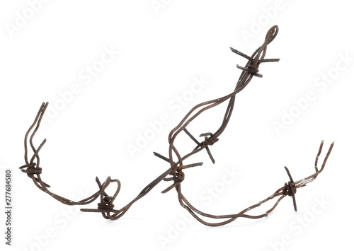 Old rusty security barbed wire fence isolated on white background and texture