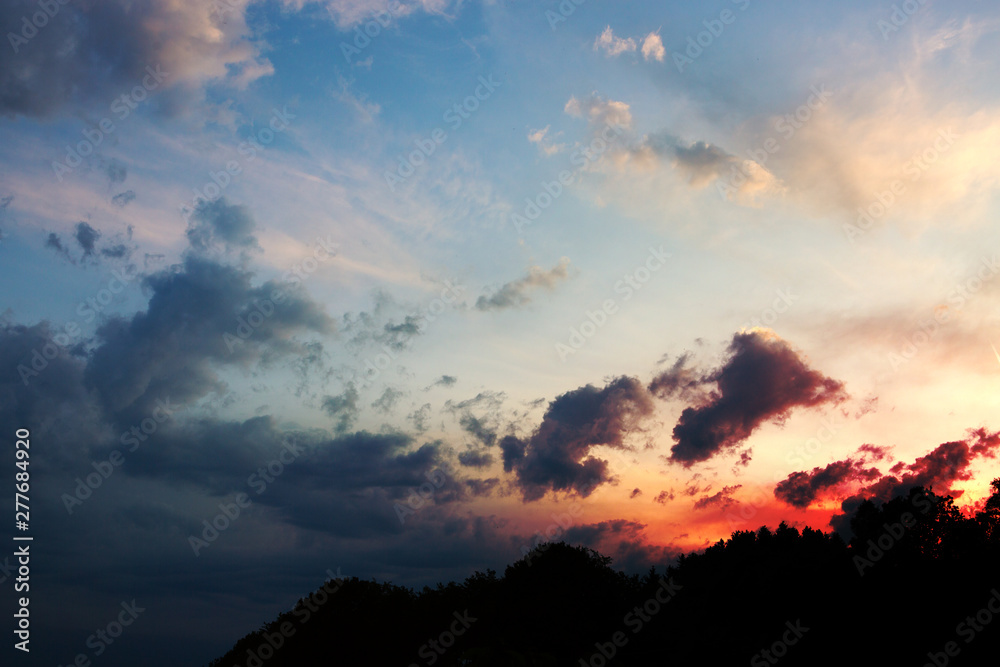 Colorful dramatic sky with big clouds at sunset. Colorful dramatic sky with big clouds at sunset.