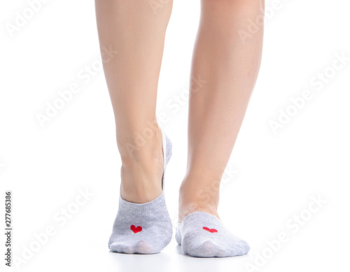 Female feet in gray no show socks on white background isolation