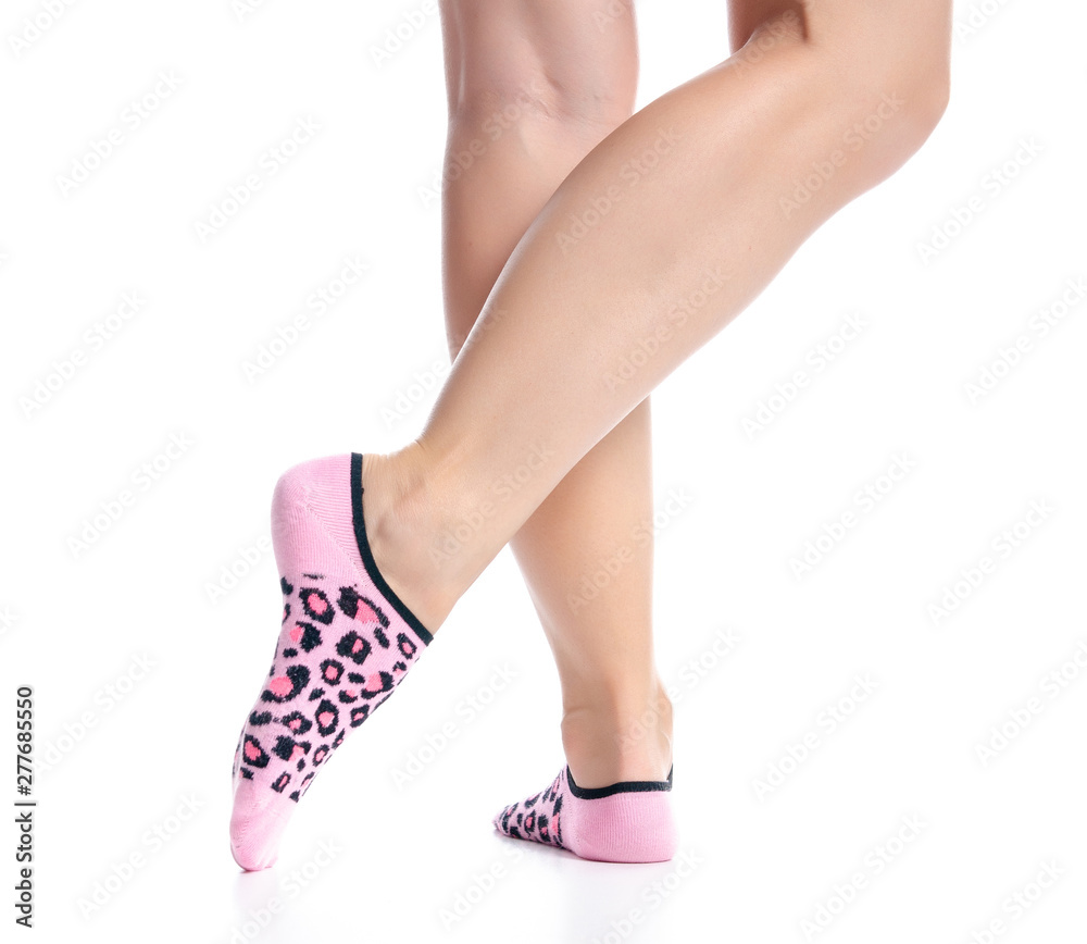 Female feet in pink no show socks on white background isolation