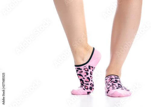 Female feet in pink no show socks on white background isolation