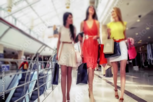 Abstract, blur background, defocusing - image for the background. Group of young attractive women making shopping