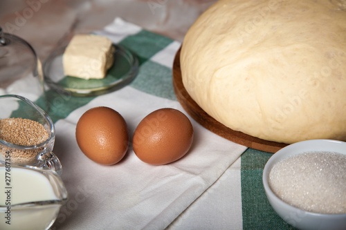 Bakery ingredients. On the table are flour, eggs and pastry dough