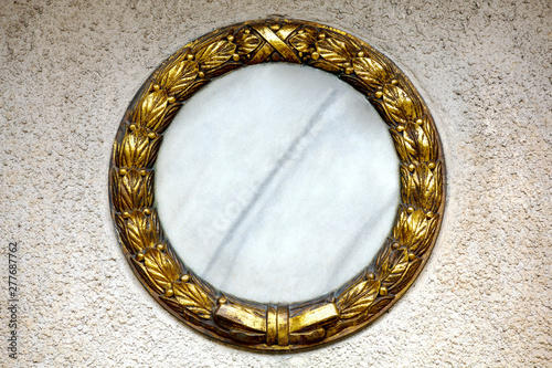 gold wreath at a gravestone