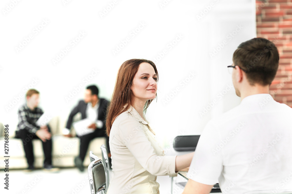 business people sitting in the lobby of the business center. business people sitting in the lobby of the business center.
