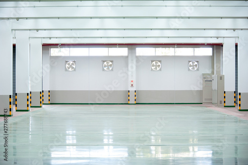 Interior of empty hall in factory with industrial fan regurator