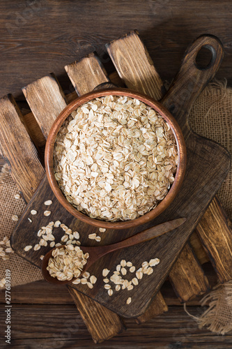Oatmeal in a wooden bowl on a wooden table