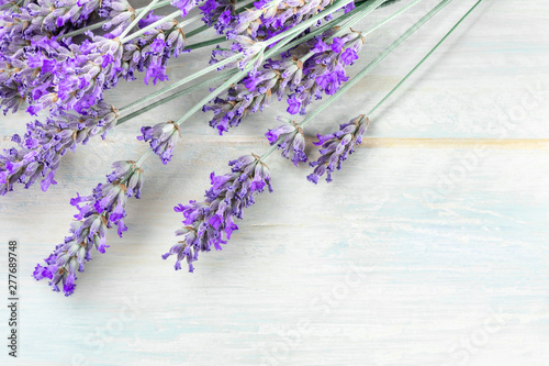 A fresh bouquet of blooming lavender flowers  shot from the top on a rustic wooden background with a place for text