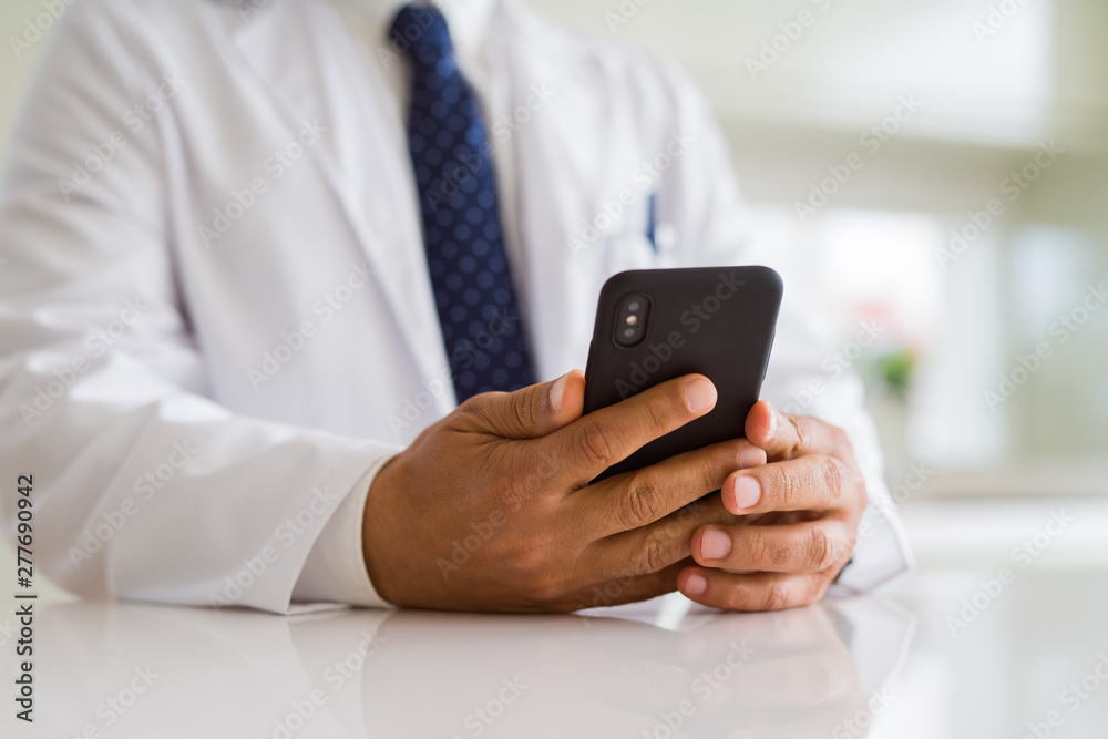 Close up middle age doctor man hands using smartphone Close up middle age doctor man hands using smartphone