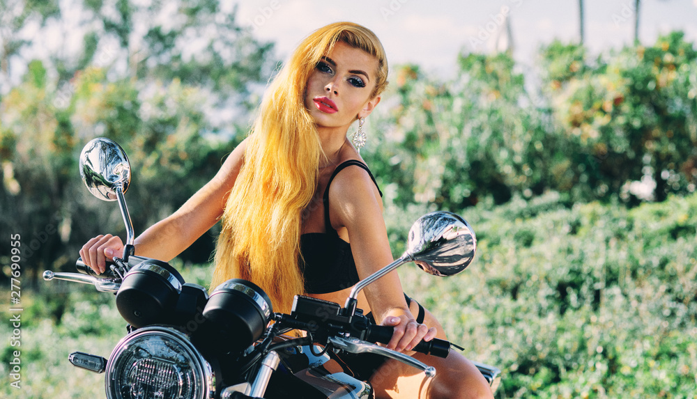 Beautiful european woman with blond long hair wearing black lingerie  sitting on motorcycle posing on nature Stock Photo | Adobe Stock
