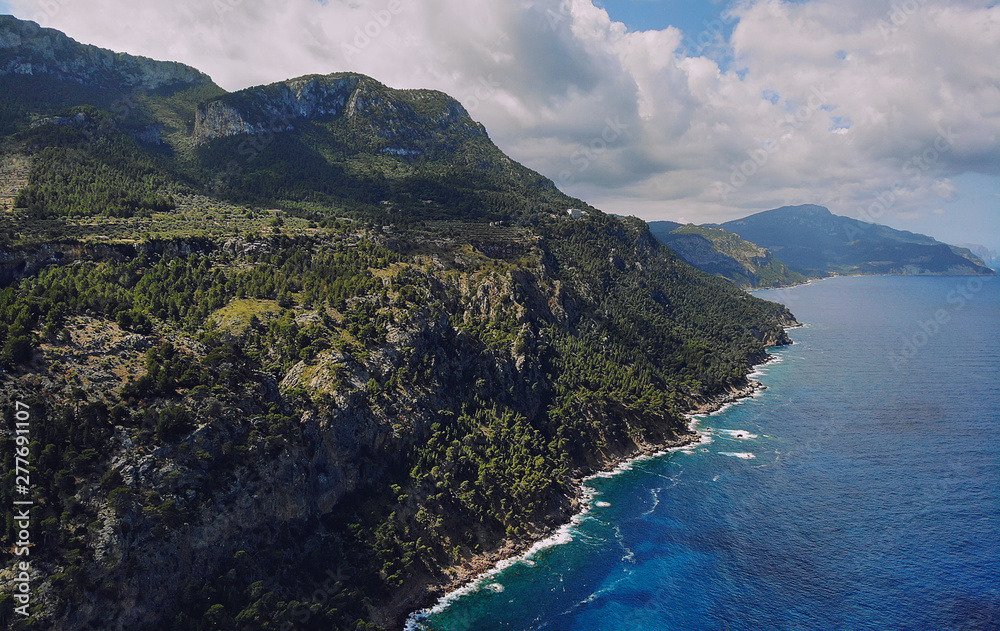 Obraz premium Picturesque aerial photo of rocky coastline of Son Marroig in the Palma de Mallorca touristic famous island, beautiful place Mediterranean sea cloudy sky at sunny summer day, Spain