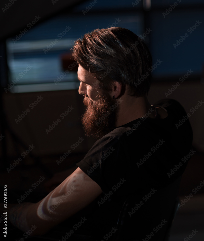 bearded serious man sitting in a chair bearded serious man sitting in a chair