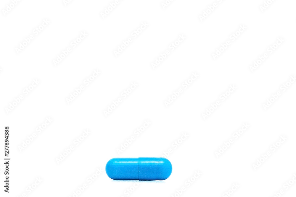 Macro view of blue capsule pill isolated over white background Macro view of blue capsule pill isolated over white background