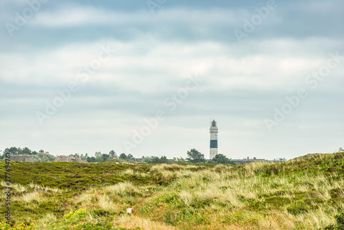 Lighthouse black white on dune.