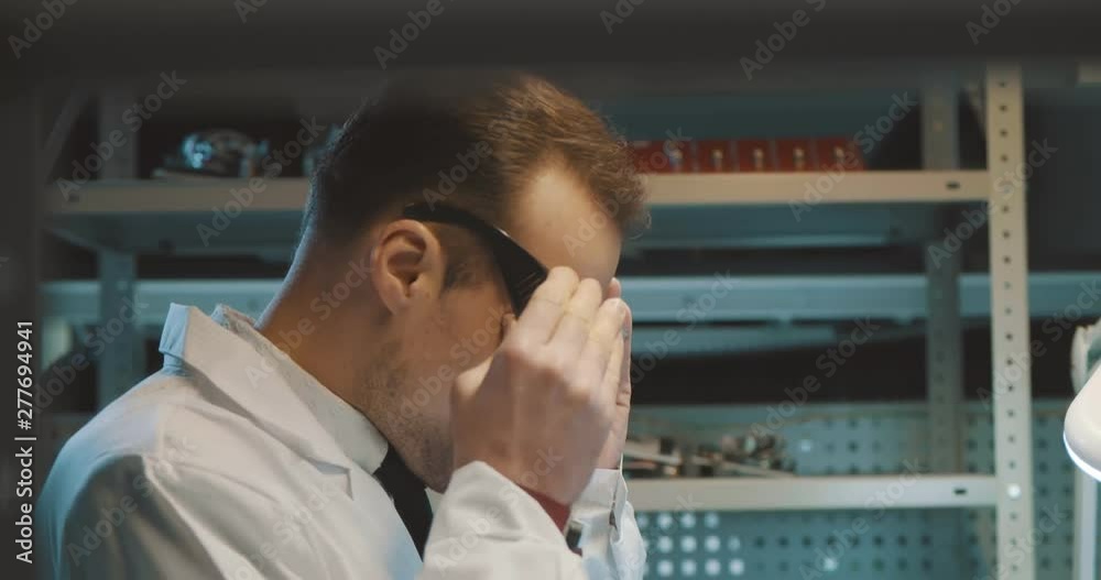 Young scientist working on his invention Young scientist working on his invention