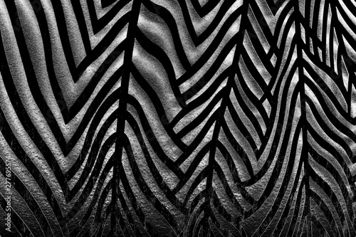 abstract contrasting black and white wall texture with three-dimensional striped pattern