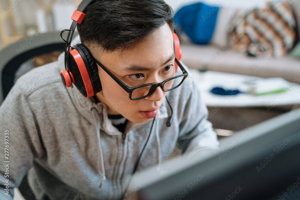 Teenager Boy Online Plays A Computer Game With Headphones And A