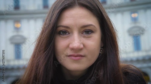 sensual cute young brunette looking at camera in the street-slow motion