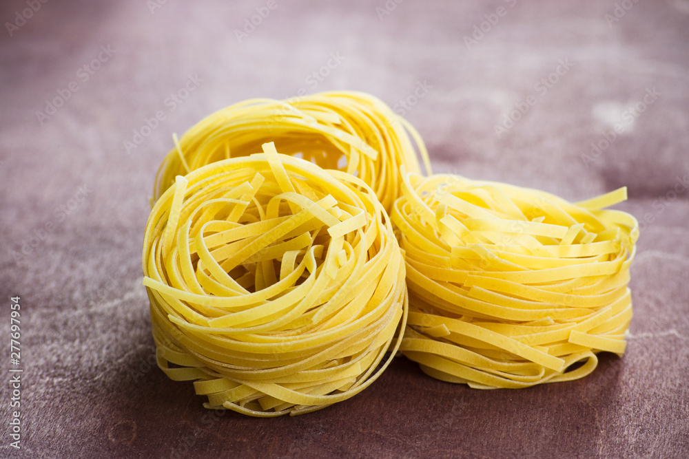 Traditional italian pasta fettuccine on a wooden table. Traditional italian pasta fettuccine on a wooden table.