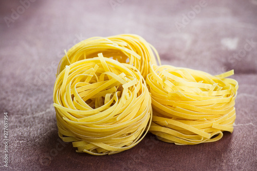 Traditional italian pasta fettuccine on a wooden table.