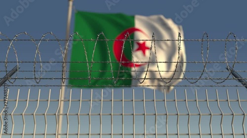 National flag of Algeria behind barbed wire fence. Conceptual loopable 3D animation photo