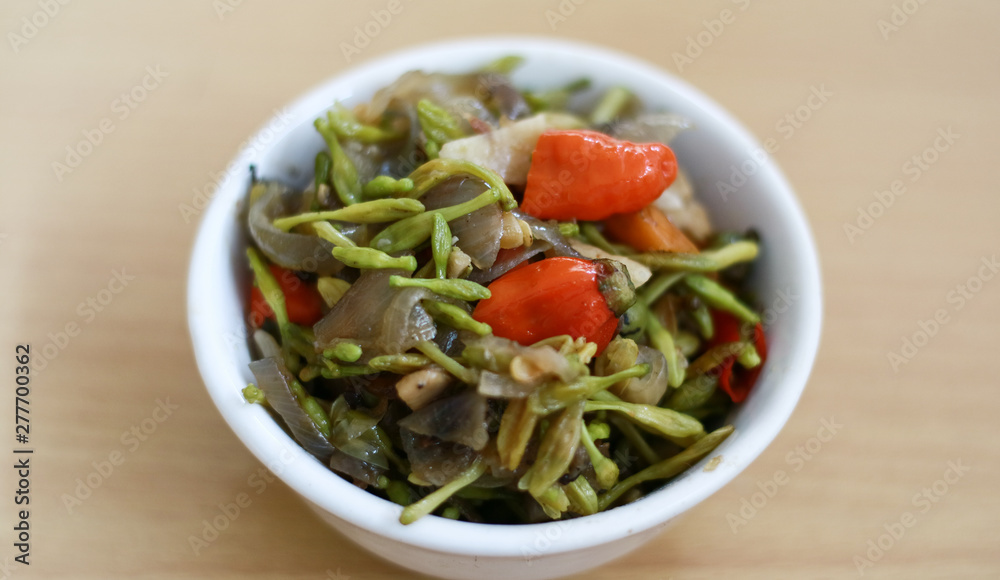 Sauteed papaya flowers on wood background. Sauteed papaya flowers on wood background.