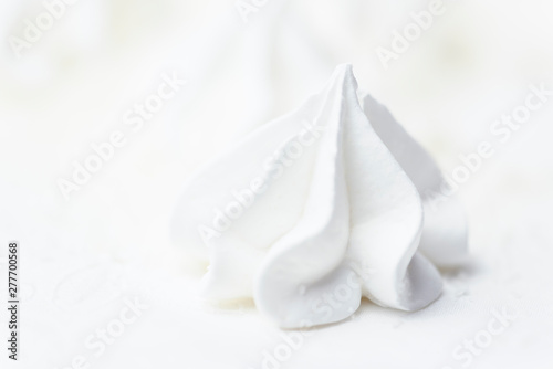 White meringue cake on white background