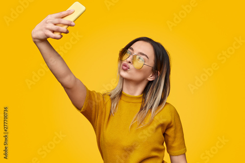 Canvas Print Stylish female pouting lips and taking selfie