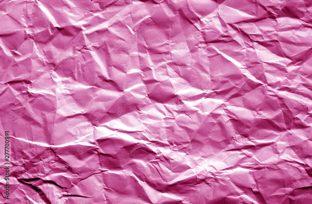 Crumpled sheet of paper with blur effect in pink color.