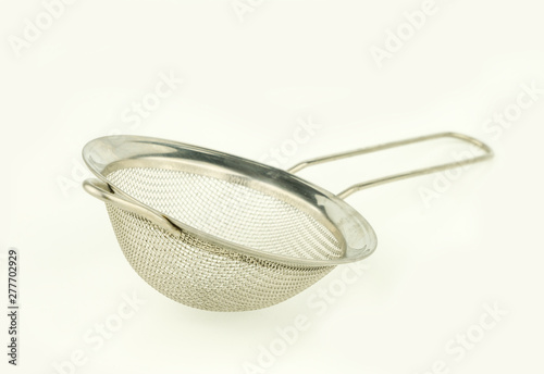 close up steel strainer on white