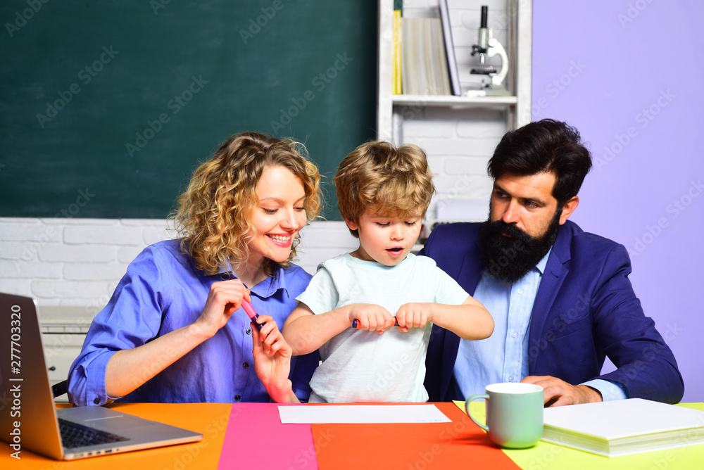 Mom and dad helps child boy. First time to school. Happy family