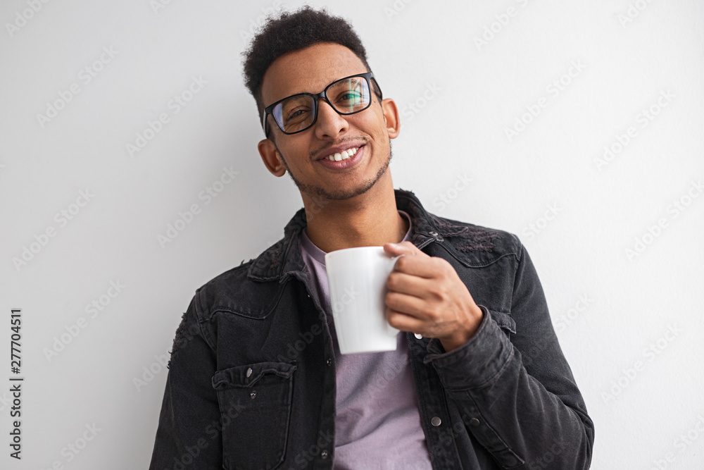 Smiling black male with hot beverage Smiling black male with hot beverage