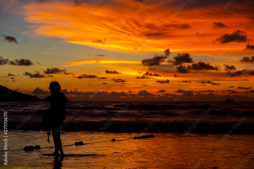 People are playing at the beach and waiting to watch the sunset. People are playing at the beach and waiting to watch the sunset.