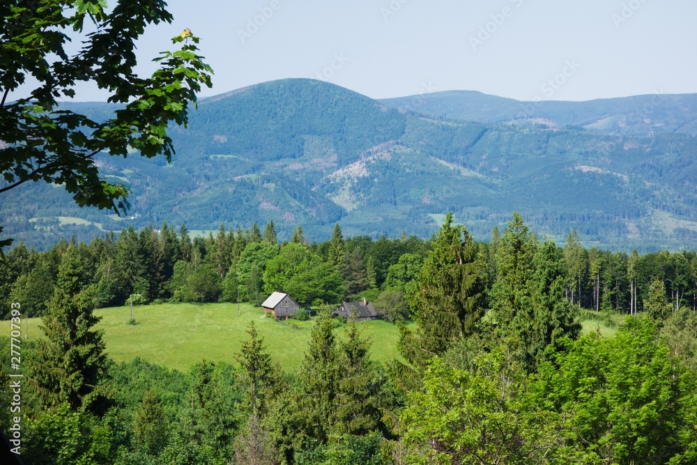 Landscape in the Beskydy mountains with old wooden houses. Moravian Silesian region, Beskydy, Czech republic, Europe. Summer day.