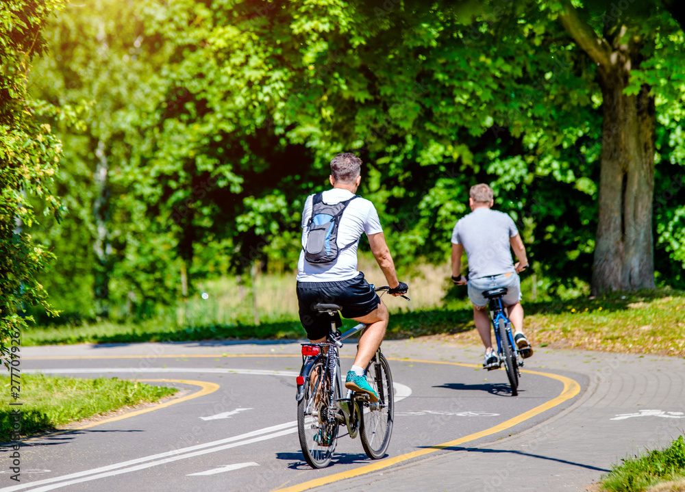 Fototapeta premium Cyclist ride on the bike path in the city Park 