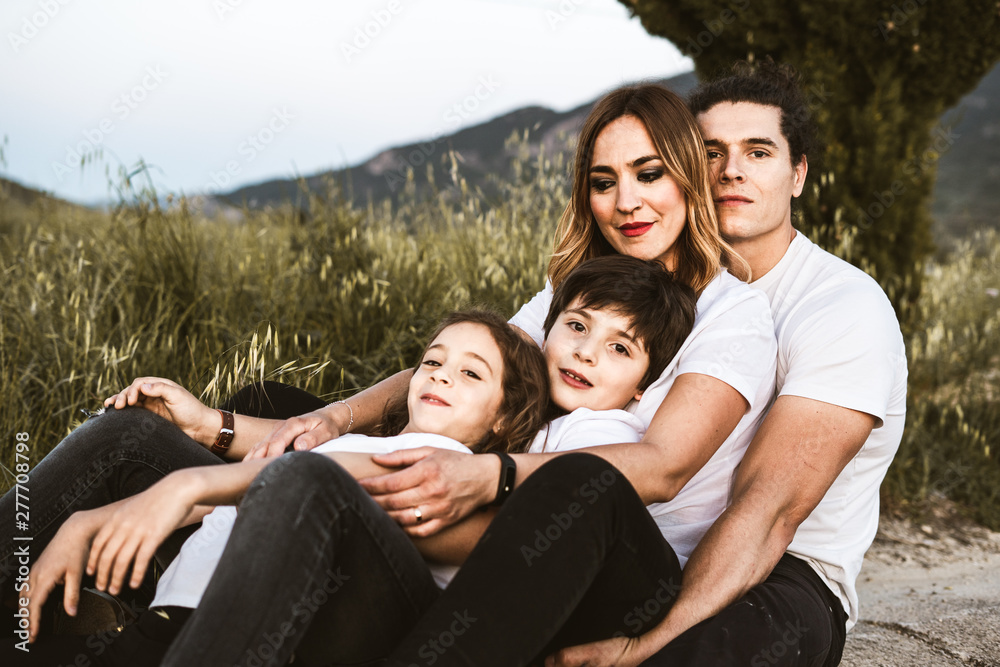 Portrait of a happy and funny young family outdoors