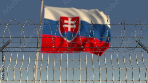 Many waving flag of Slovakia behind barbed wire fence. Conceptual loopable 3D animation photo