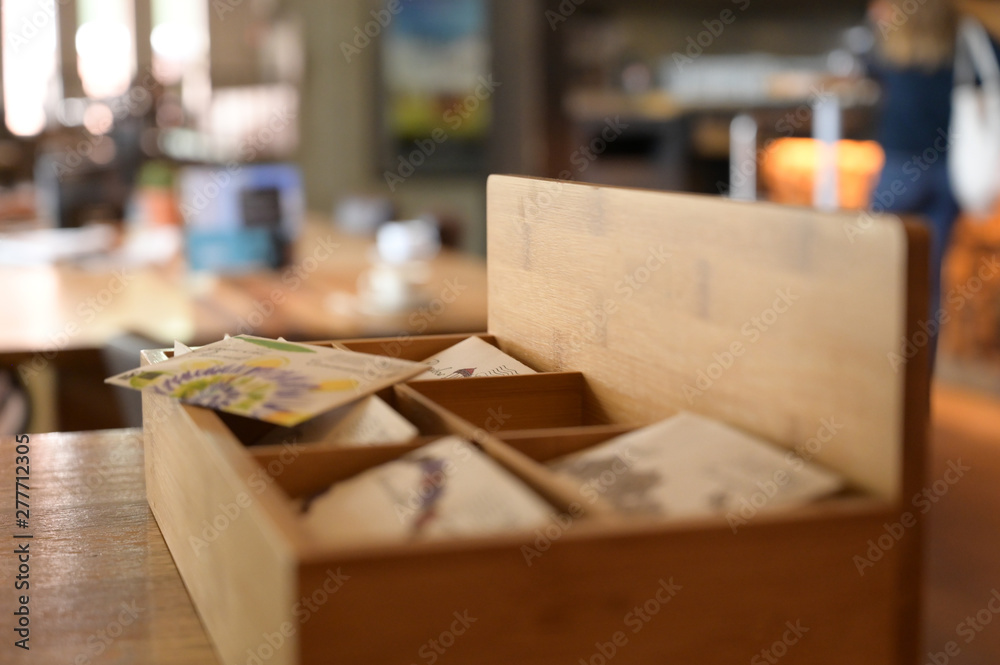 Wooden box with authentic teabags in a cultural cafe