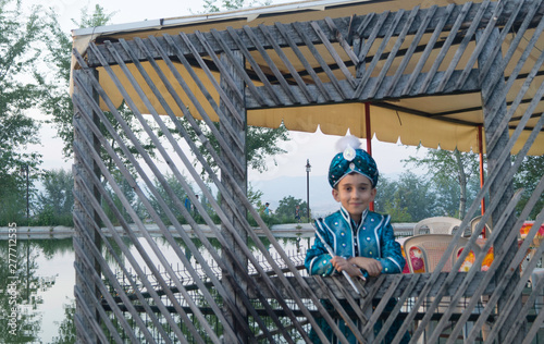 circumcision boy dressed in traditional clothing photo