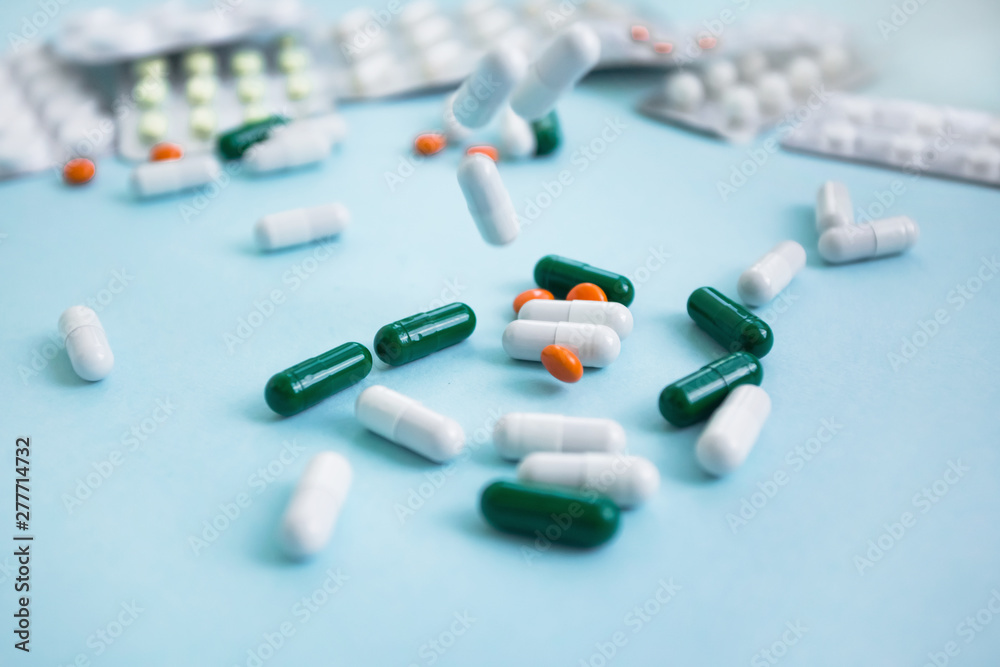 prescription capsule pills in free drop on a blue background copy space prescription capsule pills in free drop on a blue background copy space