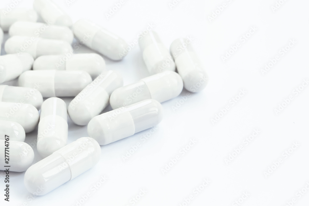 Several white capsules of drugs and pills on a white isolated background. Several white capsules of drugs and pills on a white isolated background.