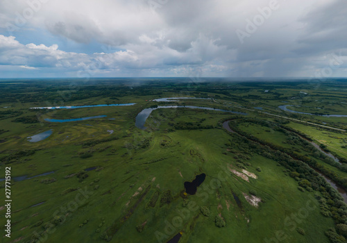 River and lakes near the Irbit city . Russia. Aerial. Summer, cloudy.  A lots of trees and grass photo