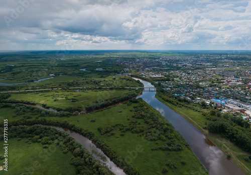 Irbit city and river. Russia. Aerial. Summer, cloudy. A lots of trees and grass © flyural66